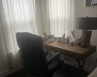 Rustic wooden desk and upholstered computer chair. 