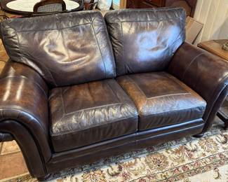 Brown leather love seat 