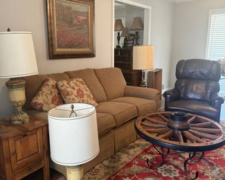 Awesome vintage lamps, beautiful condition sofa leather rocker recliner and a retro wagon wheel table without glass. 