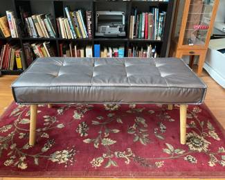 Metallic cushioned bench seat with wooden legs $100 + tax 