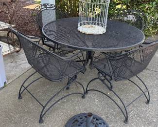 Woodward outdoor table and four spring base chairs.