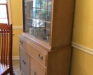 MCM wood cabinet with glass front hutch. Nice clean lines mak8ng it versatile for any room.