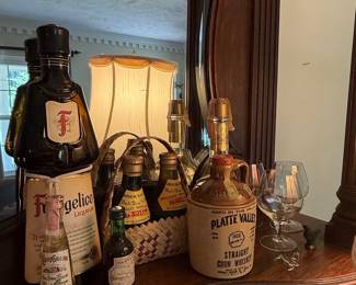 Collection of Miniature and Full-Size Liqueurs and Whiskey, including Sambuca Galliano, Frangelico, and Platte Valley Corn Whiskey
