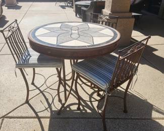 Heavy metal and tile patio table with three chairs