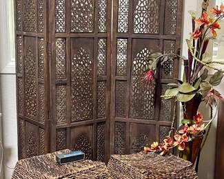 CARVED WOOD SCREEN, WICKER OTTOMANS, FAUX FLORAL ARRANGEMENT