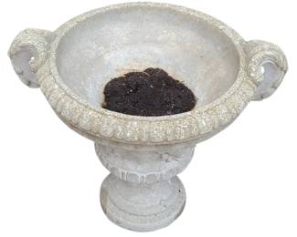 A decorative stone or concrete pedestal planter with a classic, old‑world garden style. The bowl has a textured rim and two curled scroll‑style handles on each side, giving it the look of a traditional urn. It sits on a carved pedestal base, adding height and presence. The piece shows natural outdoor wear, which enhances its vintage charm and makes it a strong accent for porches, patios, or cottage‑style gardens.  Priced at $30