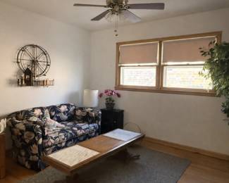 Charming vintage three-seat sofa featuring a classic floral upholstered fabric with a dark background and soft botanical pattern. This piece offers a cozy, traditional look with rolled arms and plush cushions, making it a perfect fit for a living room, den, or sunroom. The sofa has a sturdy frame and comfortable seating, showcasing the timeless appeal of vintage craftsmanship.  Couch shows wear,  Priced at $50 for the couch.  Coffee table with marble inlays priced at $75