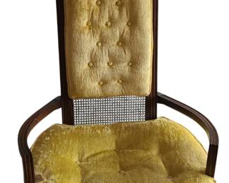 A vintage high‑back upholstered accent chair with a dark wooden frame, curved armrests, and elegant lines. The upper and lower sections of the backrest feature woven cane panels, while the center is upholstered in golden‑yellow velvet with classic button tufting. The seat cushion matches in the same velvet fabric and shows light, expected wear for its age. The combination of cane, tufting, and rich color gives the chair a warm, retro character that fits well with mid‑century, traditional, or eclectic décor.  Set of 2 - Priced at $250 for set