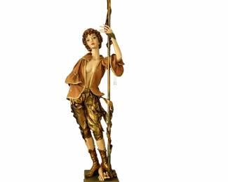 Striking vintage figural floor lamp featuring a life-size sculpted figure holding a decorative candelabra-style light fixture. The piece showcases detailed craftsmanship, with the figure dressed in classical/European-inspired attire and finished in rich gold and bronze tones.  The lamp is topped with multiple arms and tulip-style glass shades, providing both ambient lighting and dramatic visual impact. Mounted on a substantial base, this is a true statement piece—perfect for a living room, entryway, or traditional décor setting.  A highly decorative and collectible item that blends lighting with sculptural art.  Priced at $200 as one hand is broken off but could be glued back on.   Lamp in working condition,