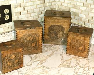 A set of four hand‑carved wooden boxes, each featuring dovetail joints and a circular lift‑top indentation. The fronts display a floral/leaf motif, giving them a rustic, artisan feel. The natural wood grain shows beautifully, and the craftsmanship suggests they were made as decorative keepsake or trinket boxes. They vary slightly in size, making them ideal for stacking, display, or organizing small items.  These pieces fit well with boho, rustic, farmhouse, or vintage décor.  Priced at $50 for the set