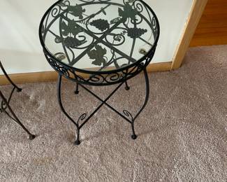 Decorative round accent table featuring a glass top and ornate metal base with a grapevine motif. The design includes sculpted grapes, leaves, and scrollwork, giving it a classic Tuscan or vineyard-inspired look.  The glass top allows the intricate metal detailing to show through, making it both functional and visually appealing. Perfect as a side table, plant stand, or accent piece in a living room, sunroom, or patio-style space.  Condition:  Good condition with light wear consistent with age. Glass top intact; metal frame is sturdy.  Priced at $45