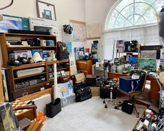 Electronics room stuffed full with MCM desk, closet full.