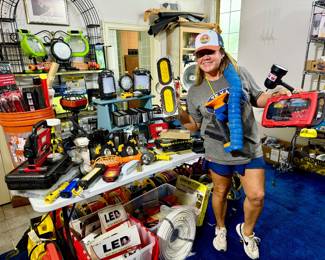 Shauna showing off the blue room full of lighting of all kinds!  LED, bulbs, cords, extension cords, wiring, etc.
