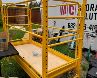 Adjustable scaffolding with guard rails.