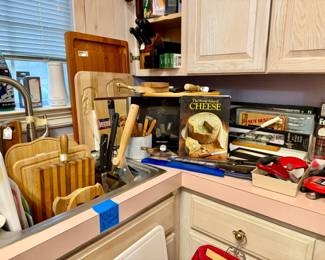 Laundry room with so many utensils, cutting boards, knives.  It took Tiff 10 hours to price all of the utensils. 