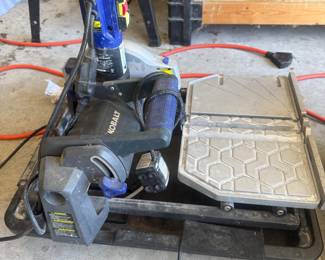 Garage automotive creeper seat with padded seat and metal frame on wheels.