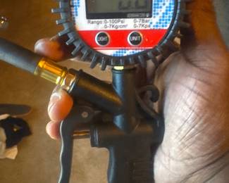 Handheld digital gauge with display and handle, branded 'Total', possibly for pressure measurement.