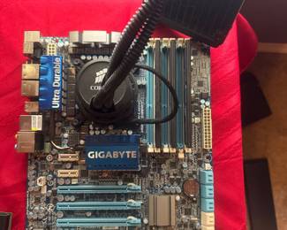 Gigabyte computer motherboard with various components and ports, pictured on a red background.