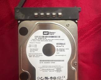 Internal hard drive with visible label and connectors, placed on red fabric.