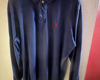 Dark navy long-sleeve polo shirt with collar and small red embroidered logo on the chest.