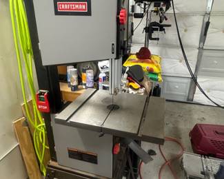 Craftsman tool cabinet with a benchtop drill press and various tools in the garage.