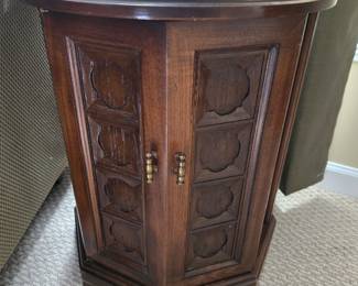 Vintage mid-centruy hexagon storage end table featuring ornate paneled doors and brass hardware. $50