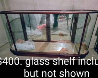 Beautiful curved display case. Wood rim, mirror doors in back, glass surround.  Includes glass shelf that can be placed in middle.