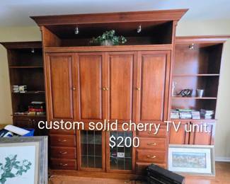 Custom solid cherry TV unit. 12' long, 100" tall, 2' deep.  TV cavity is 46x70.  All custom made.  Some drawers with DVD holder slots.  Top shelf lighting, movable shelves, leaded glass doors for electronics $200