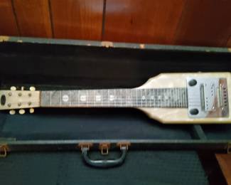 PRESALE- $200 The instrument in the image is a vintage lap steel guitar, specifically identified as a mid-century Oahu model manufactured by Valco. These instruments were highly popular during the 1940s and 1950s for Hawaiian and country music.  Guitar Center Guitar Center  +2 Key Features and Identification Body Material: Many models from this era, such as the "Symphony in White," feature a pearloid finish (often referred to as "mother of pearl") over a wood body. 