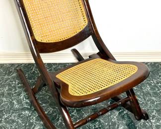 Antique Rocker with Cane Seat and Carved Rose Design 