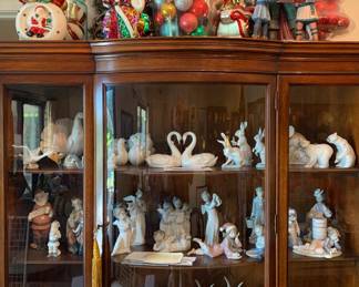 1950s Drexel Mahogany Bow Front China Cabinet Filled with Lladro and Lenox Animals, Christmas, Candle Holders,and Religious Figurines