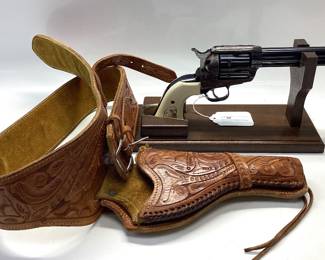 Strum Ruger Vaquero 45 cal. Classis western 6 shot features jeweled hammer, trigger and eagle grips. It is holstered with a custom leather belt and holster. All guns, pistols, rifles and shotguns are subject to FFL firearms regulations