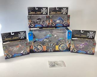 5) WEST COAST CHOPPERS DIE CAST MOTORCYCLES The four 1.18 motorcycles have damage pieces are in a bag with tin of Harley Davidson playing cards