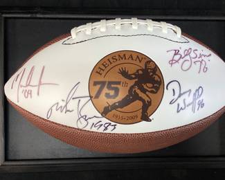 AUTOGRAPHED WINNERS 75th ANNIVERSARY HEISMAN TROPHY FOOTBALL, 1978 BILLY SIMS #20 OKLAHOMA SOONERS, 1983 MIKE ROZIER #30 NEBRASKA CORNHUSKERS, 1996 DANNY WUERFFEL #7 FLORIDA GATORS, 2004 MATT LEINART #11 USC TROJANS IN DISPLAY CASE NO SHIPPING PICKUP ONLY