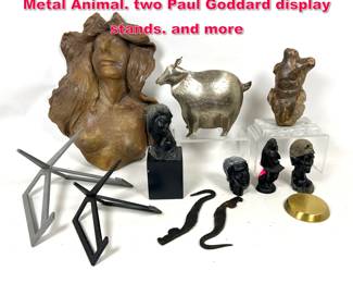 Lot 486 Assorted Shelf lot. Carved Busts. Metal Animal. two Paul Goddard display stands. and more