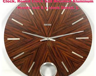 Lot 407 HOWARD MILLER Exotic Wood Wall Clock. Round Clock had Brushed Aluminum Hands and 6 o clock Detail. L
