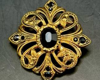 vintage Avon gold-tone jewelry enhancer pendant featuring a black onyx center stone