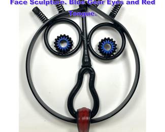 Lot 790 Found Object and Iron Modernist Face Sculpture. Blue Gear Eyes and Red Tongue. 