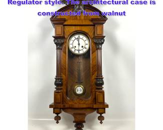 Lot 1133 Antique wall clock in the Vienna Regulator style. The architectural case is constructed from walnut 