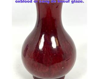 Lot 1004 Asian Porcelain Vase in mottled oxblood or sang de boeuf glaze. 