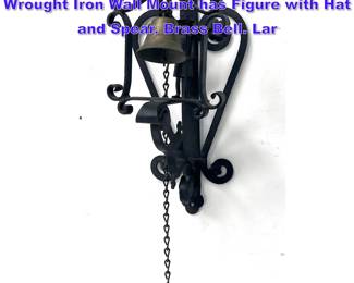 Lot 1159 Figurative wall mounted bell. Wrought Iron Wall Mount has Figure with Hat and Spear. Brass Bell. Lar