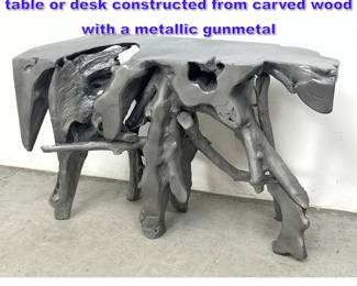 Lot 757 Contemporary sculptural console table or desk constructed from carved wood with a metallic gunmetal 