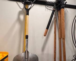 Post hole diggers, a push broom and a wide square head shovel