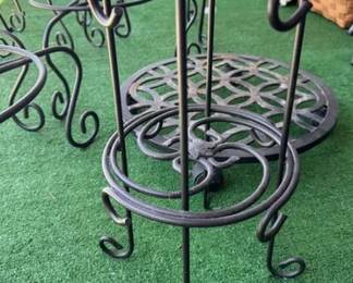 Assortment of plant stands and a rolling plant caddy