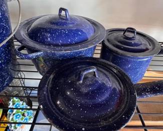 Assorted blue enamelware pots and pans