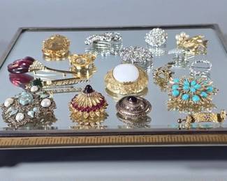 Beveled glass footed tray and collection of brooches