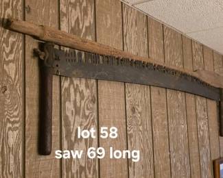 Vintage boat oar and antique crosscut saw, used as decoration