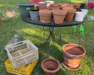 Iron table, terracotta pots 