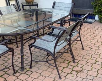 Vintage Outdoor Glass Dining Table with 6 Sling Patio Chairs, featuring a durable aluminum frame and breathable sling fabric  Table 85” L x 43” W x 29”H  Chairs - 24”W x 28”D x 32”H