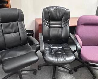 Update your workspace with this lot of three professional-grade office chairs, featuring a high-quality "hero" chair in like-new condition. Premium Black Executive Chair: The standout of the lot, this high-back executive chair features plush black faux-leather upholstery with contoured lumbar support and padded armrests. It is in excellent condition. Global Upholstery Co. Task Chair: A professional-grade ergonomic task chair by Global Upholstery Co. (a well-known Canadian manufacturer). It features a unique purple/burgundy woven fabric upholstery and a durable black frame. Classic Ribbed Executive Chair: A secondary black high-back chair featuring a horizontal ribbed design for added comfort and a classic professional look. Condition: The primary black chair is in great shape. The Global Upholstery chair and the ribbed chair show standard signs of professional use but remain fully functional with smooth-rolling casters Smoke free pet free